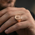 Load image into Gallery viewer, Rose gold plated Virgin Mary oval signet ring worn on finger, Marian religious ring, elegant lifestyle photo
