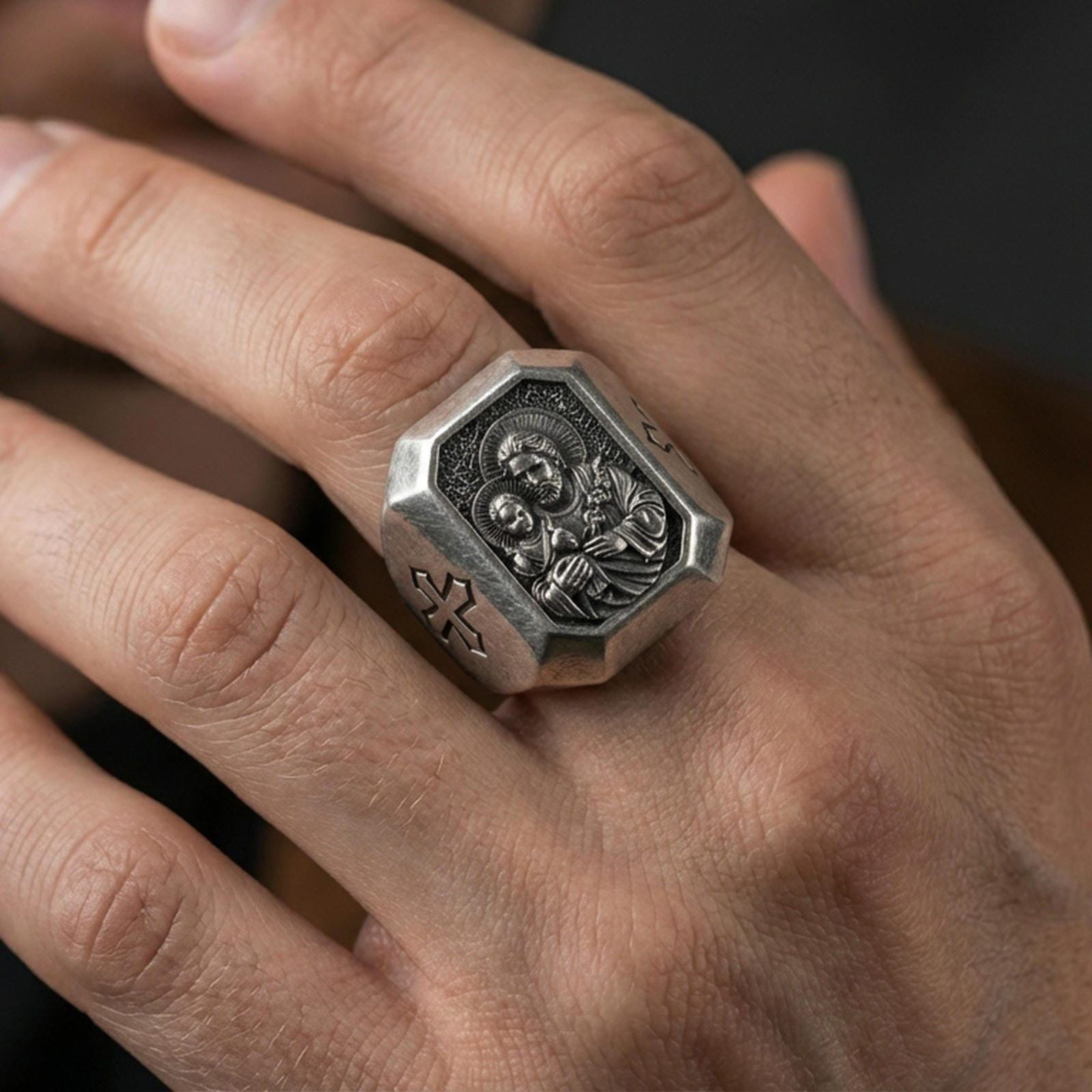 Oxidized sterling silver St Joseph signet ring worn on finger, octagon face saint relief, Catholic mens jewelry close-up