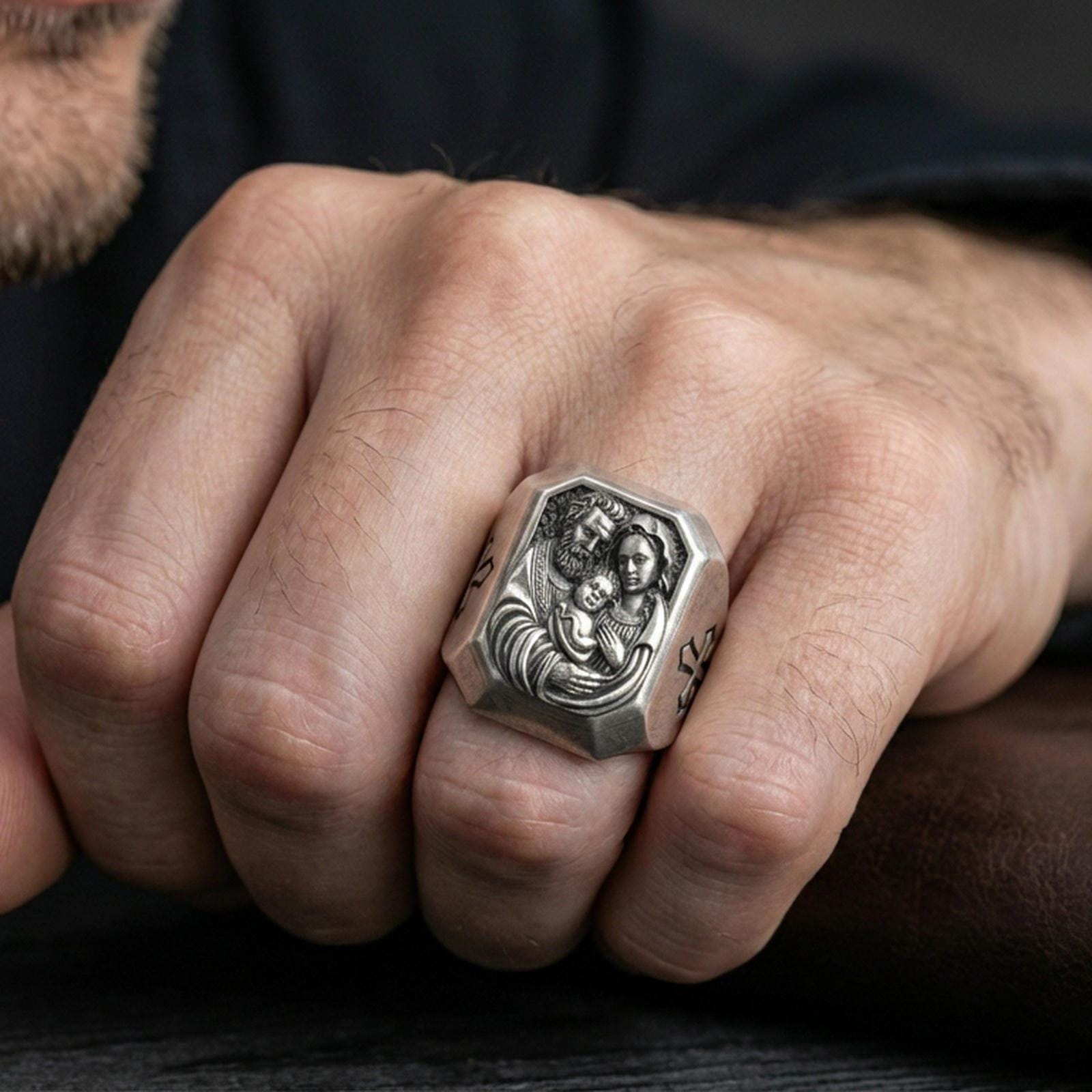 Oxidized sterling silver Holy Family ring worn on finger, St Joseph Mary and child Jesus relief, cross side detail