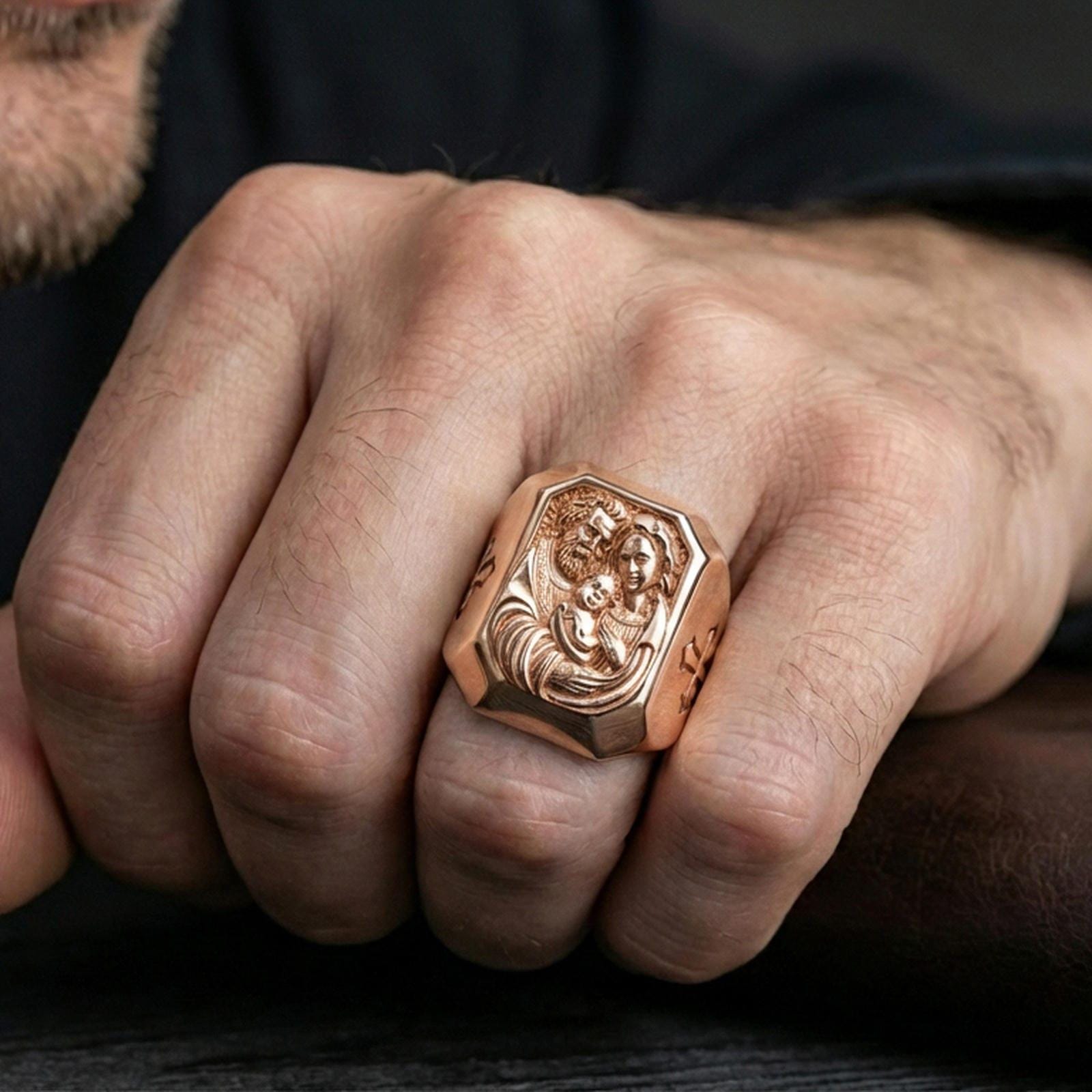 Rose gold plated Holy Family ring worn on finger, Holy Family portrait relief ring, devotional jewelry lifestyle close-up