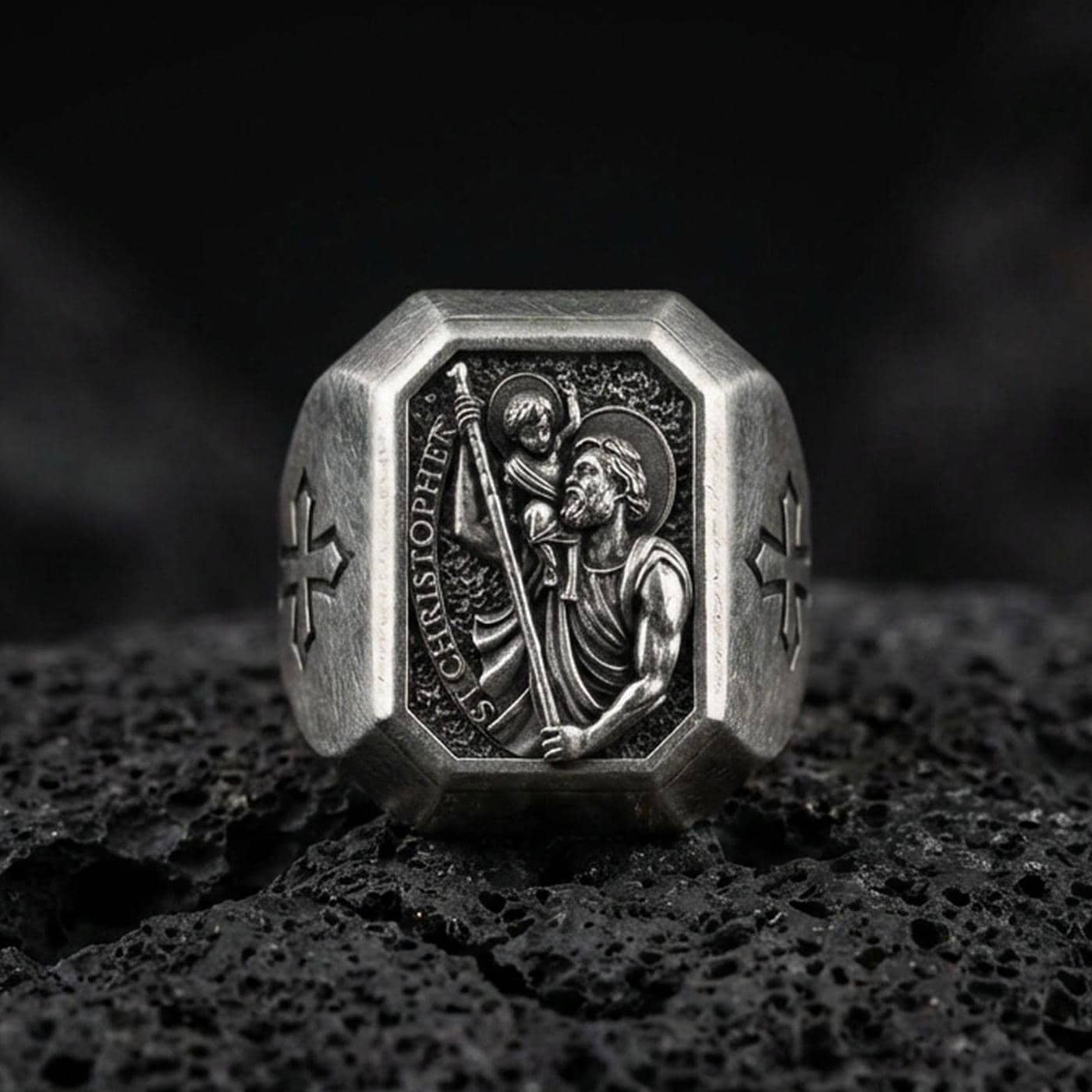 Oxidized sterling silver St Christopher signet ring on volcanic rock, patron saint traveler relief, cross side detail