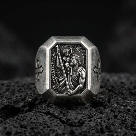 Oxidized sterling silver St Christopher signet ring on volcanic rock, patron saint traveler relief, cross side detail