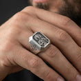 Load image into Gallery viewer, Oxidized sterling silver St Jude ring worn on finger, saint relief signet, cross side engraving close-up
