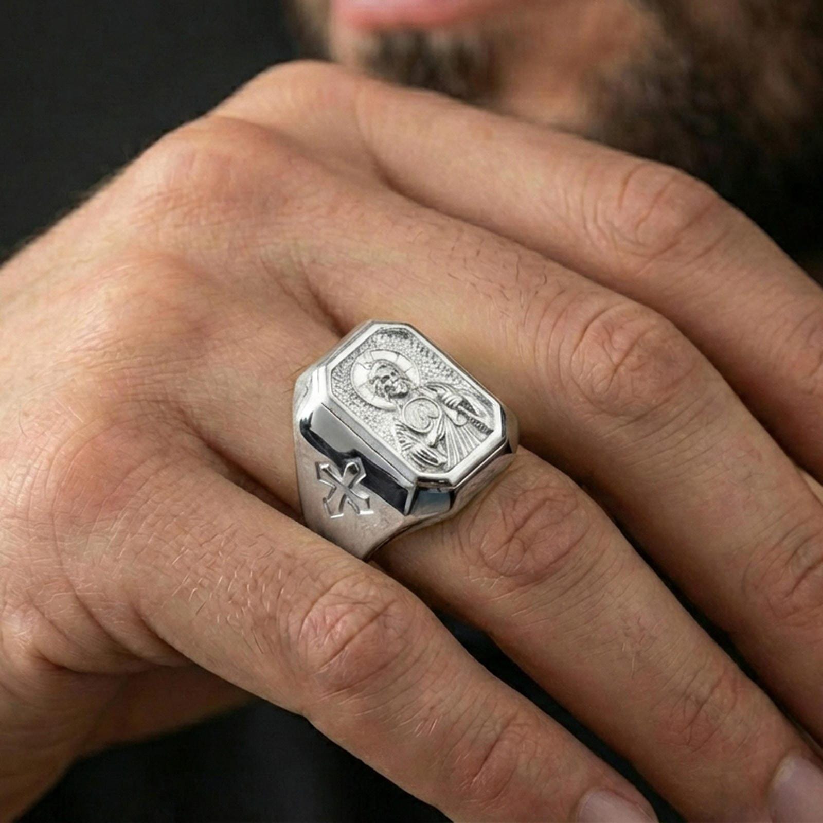 Polished silver St Jude signet ring worn on finger, detailed halo portrait, Christian devotion jewelry
