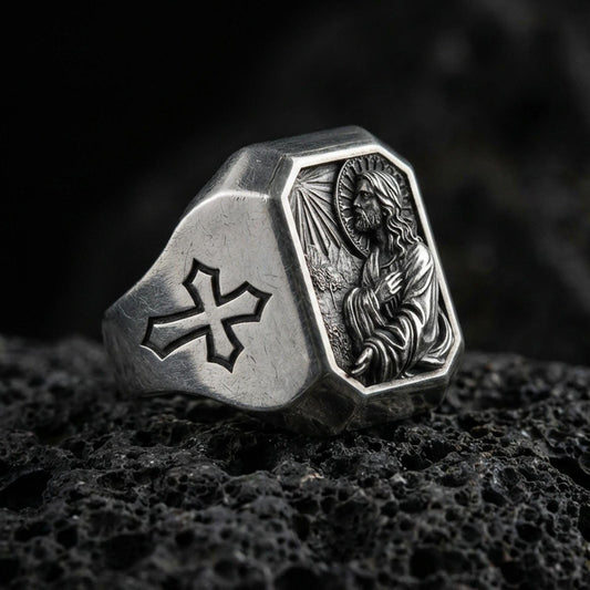 Oxidized sterling silver Jesus Christ signet ring on volcanic rock, prayer scene relief, cross shoulder engraving