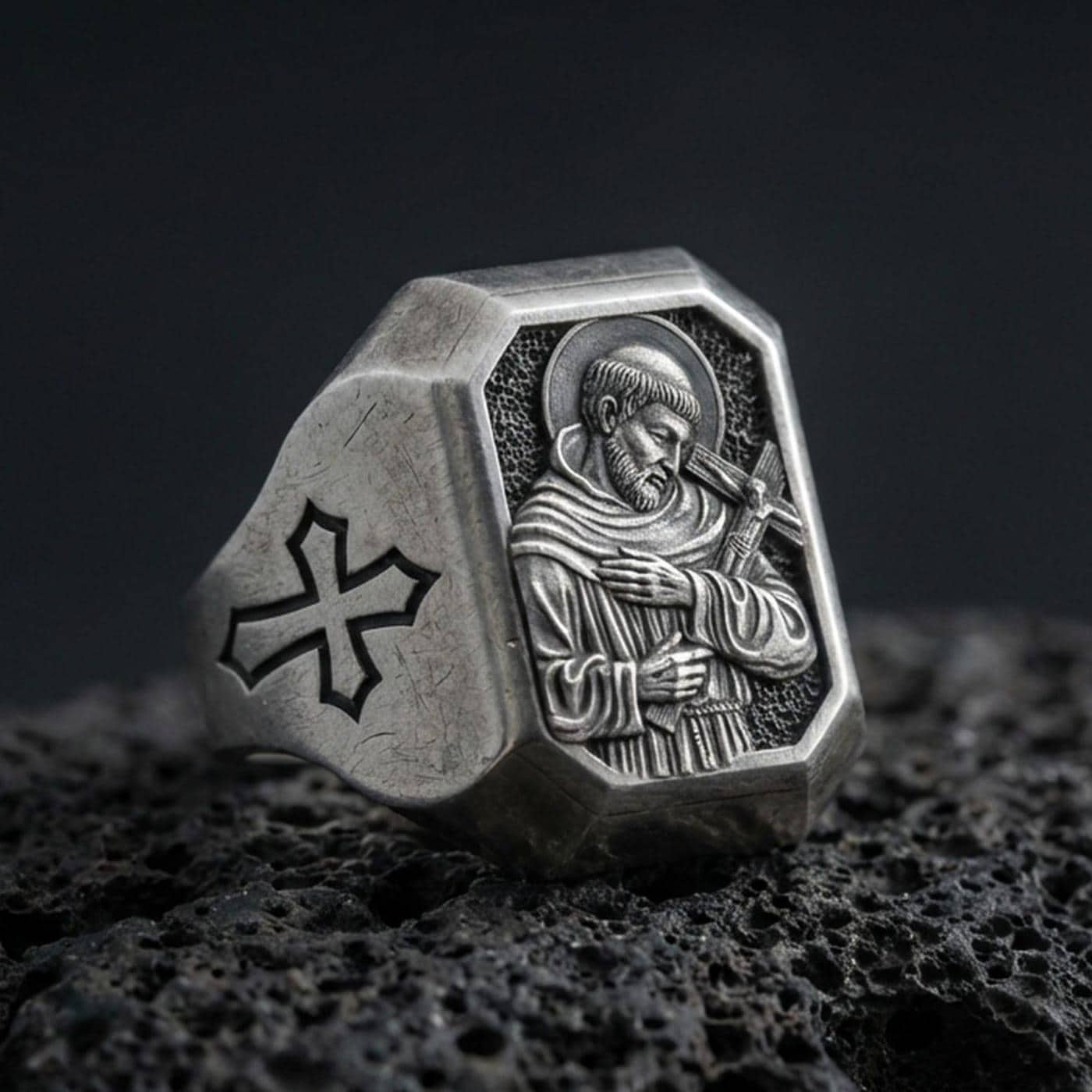 Oxidized sterling silver Saint Francis signet ring on volcanic rock, engraved saint icon, cross shoulder detail