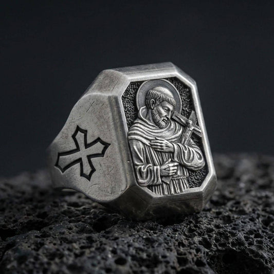 Oxidized sterling silver Saint Francis signet ring on volcanic rock, engraved saint icon, cross shoulder detail