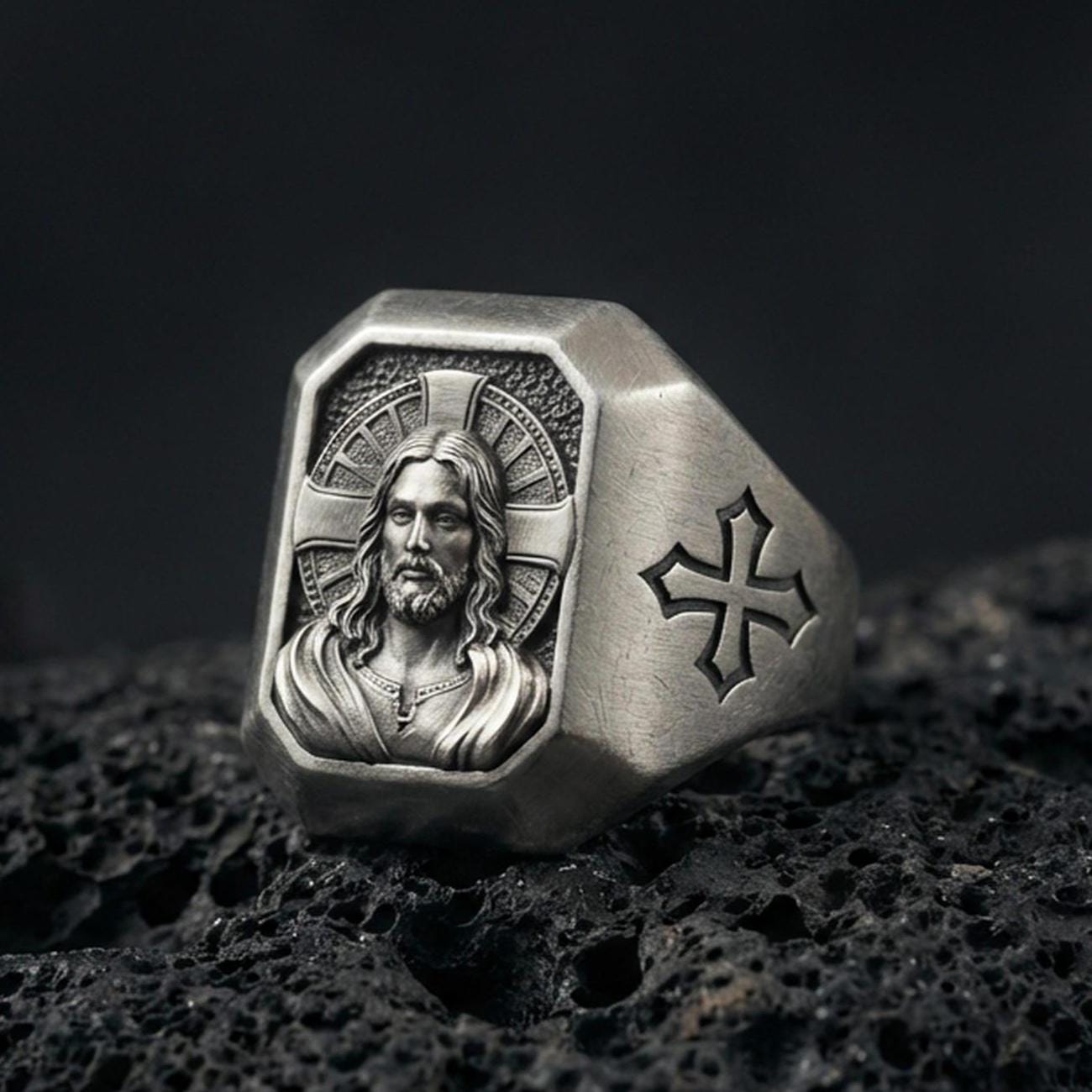 Oxidized sterling silver Jesus Christ signet ring on volcanic rock, sacred portrait relief, cross shoulder engraving