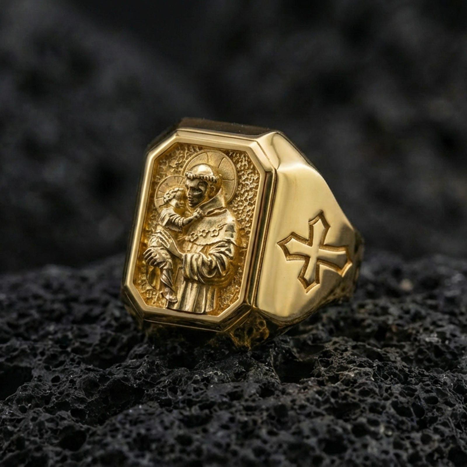 Gold plated St Anthony signet ring on dark volcanic rock, saint and child relief, cross side accent