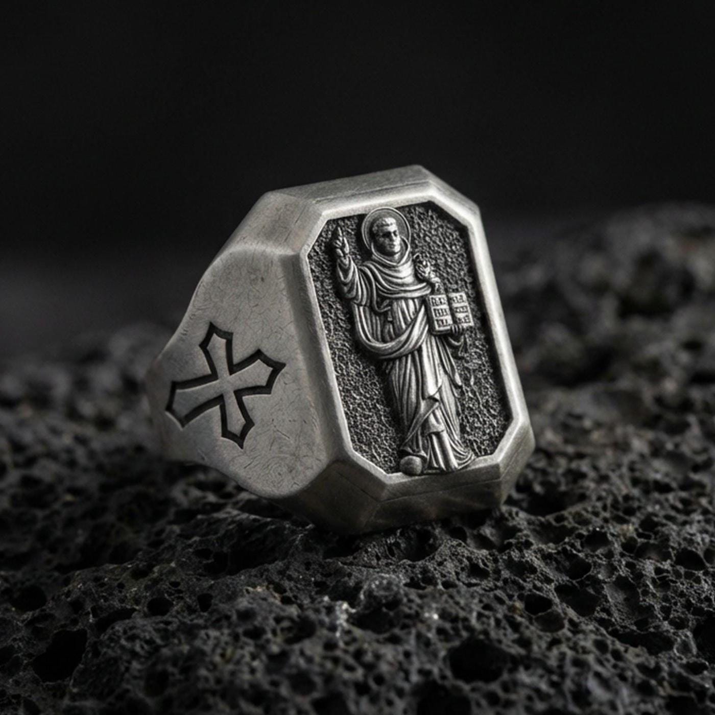 Oxidized sterling silver St Dominic signet ring on volcanic rock, saint relief holding book, cross shoulder engraving