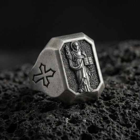 Oxidized sterling silver St Dominic signet ring on volcanic rock, saint relief holding book, cross shoulder engraving