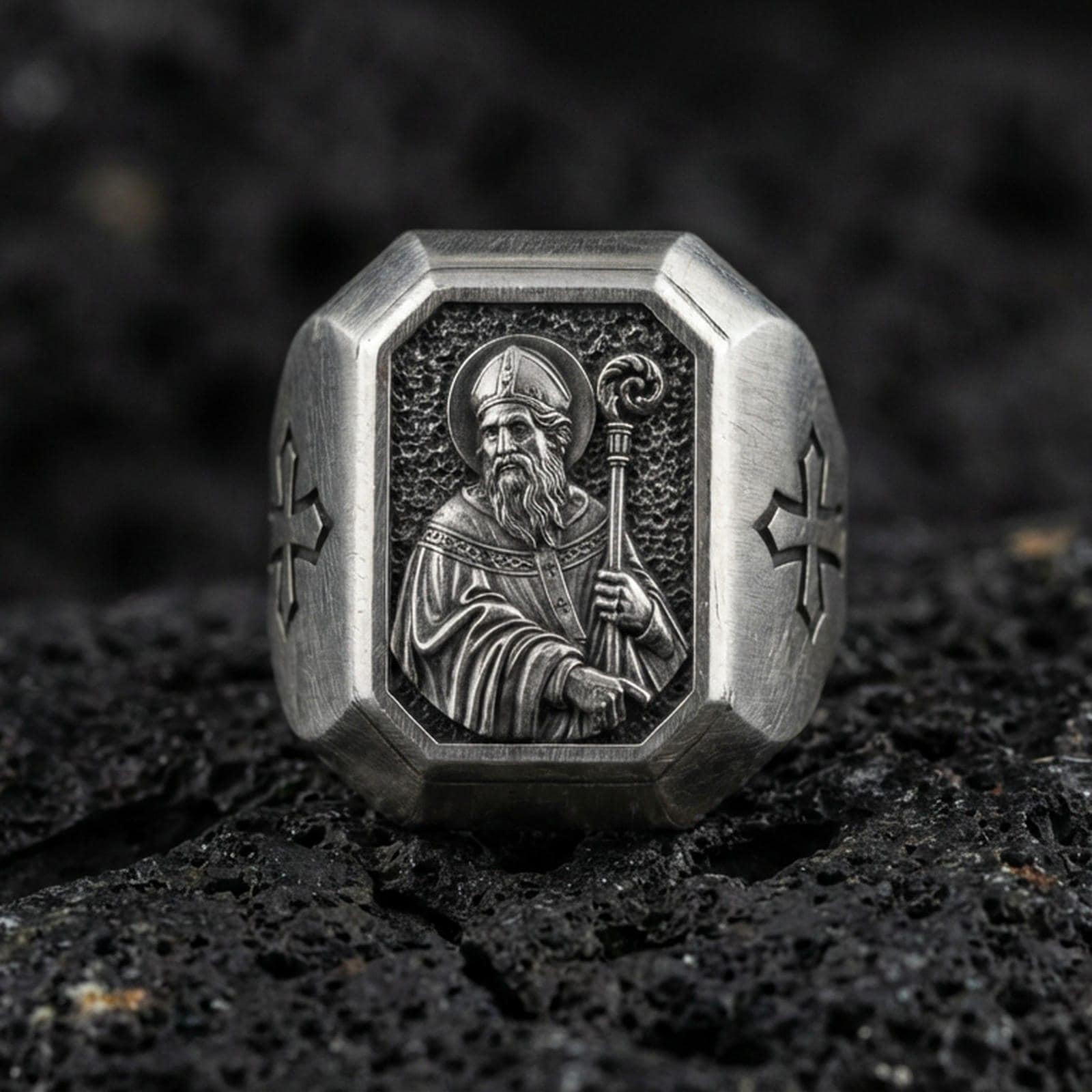Oxidized sterling silver St Patrick signet ring on volcanic rock, saint bishop relief with crozier, cross side engraving