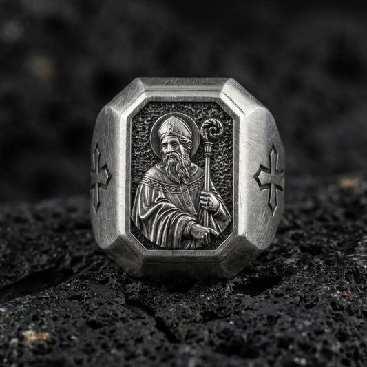 Oxidized sterling silver St Patrick signet ring on volcanic rock, saint bishop relief with crozier, cross side engraving