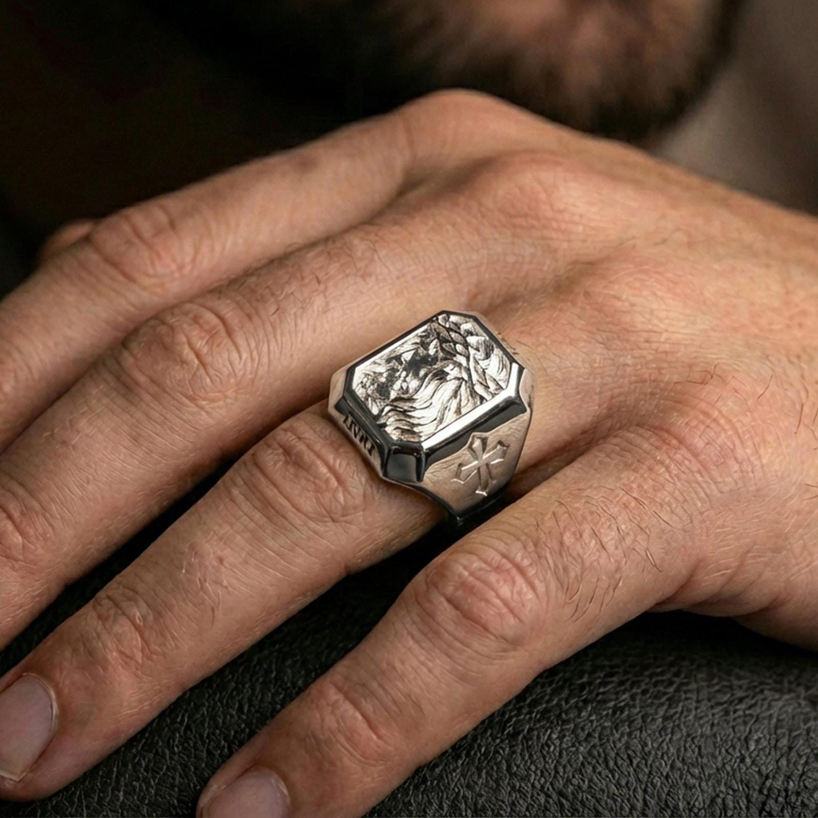Polished silver Jesus Christ signet ring worn on finger, crown of thorns side portrait engraving, Christian faith jewelry