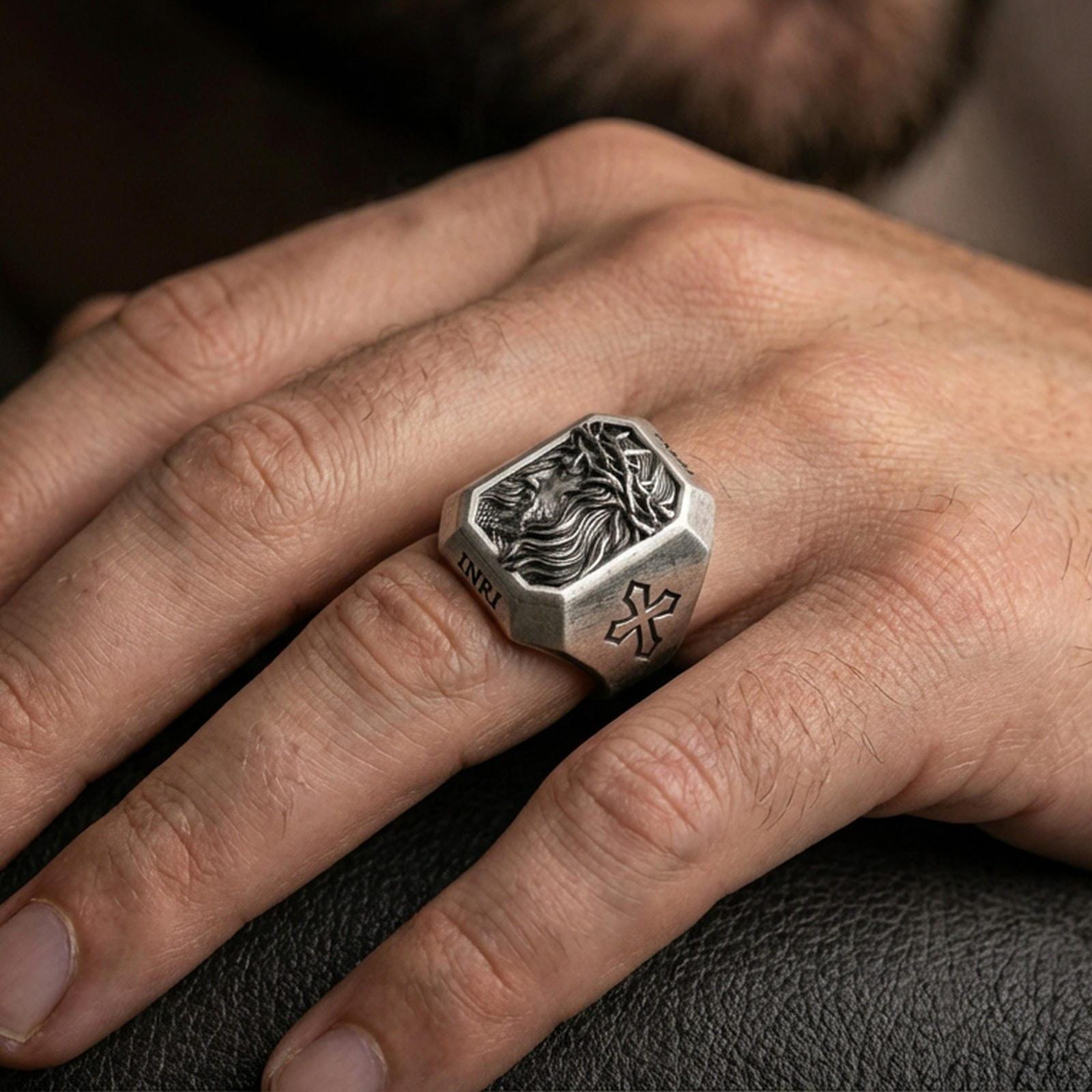 Oxidized sterling silver Jesus crown of thorns ring worn on finger, side-profile Christ relief, cross shoulder engravings
