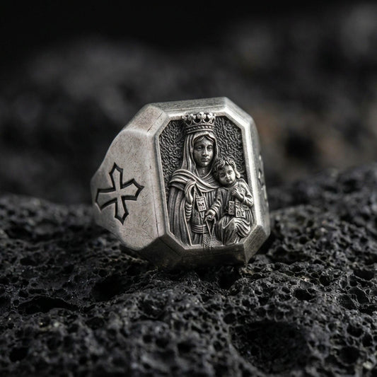 Oxidized sterling silver Virgin Mary ring on volcanic rock, crowned Madonna and Child relief, cross shoulder engraving close-up