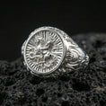 Load image into Gallery viewer, Polished silver St George ring on porous volcanic stone, detailed dragon battle engraving, religious warrior signet ring
