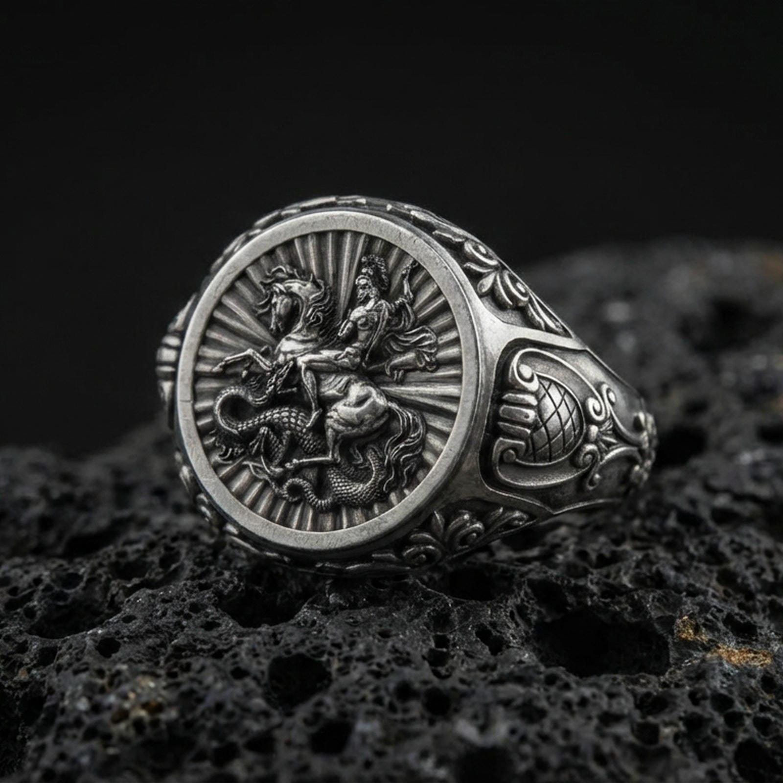 Oxidized sterling silver St George signet ring on volcanic rock, saint slaying dragon relief, Christian protector ring