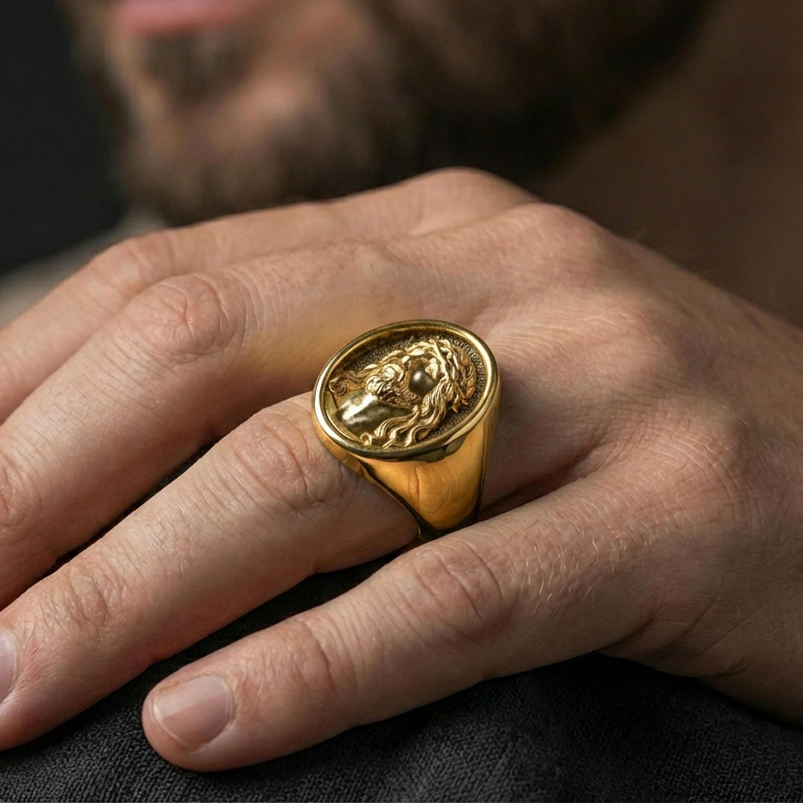 Gold plated Jesus signet ring worn on finger, statement Christian jewelry gift for him closeup