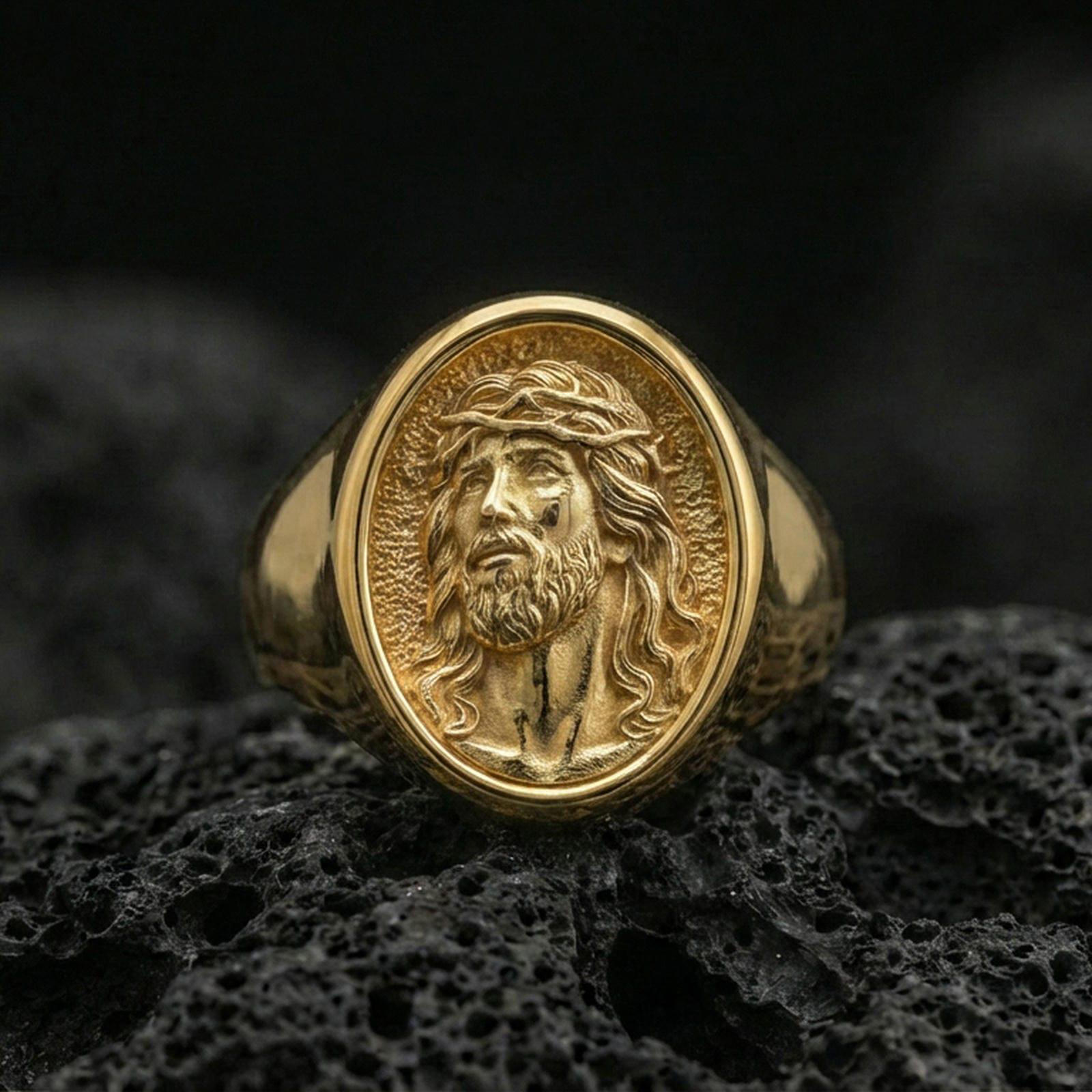 Gold plated Jesus signet ring on volcanic rock, crown of thorns devotional ring for men closeup