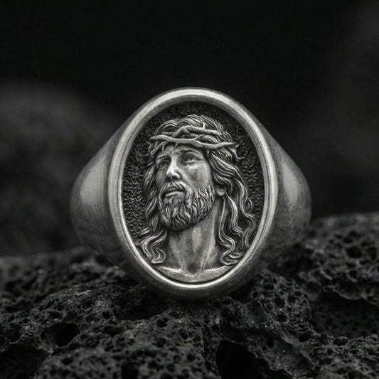 Oxidized 925 sterling silver Jesus signet ring on volcanic rock, crown of thorns Savior portrait closeup