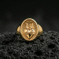 Load image into Gallery viewer, Gold plated Sacred Heart signet ring on dark volcanic rock, cross and flame heart motif, religious jewelry gift
