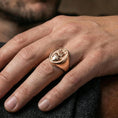 Load image into Gallery viewer, Rose gold plated Sacred Heart signet ring worn on finger, cross and flame heart design, devotional statement ring
