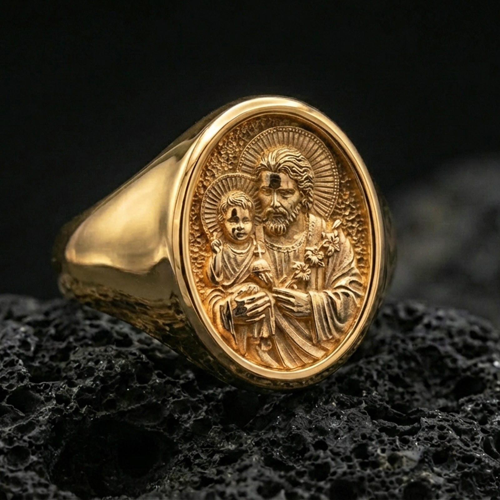 Gold plated St Joseph signet ring on volcanic rock, Christian devotion jewelry closeup