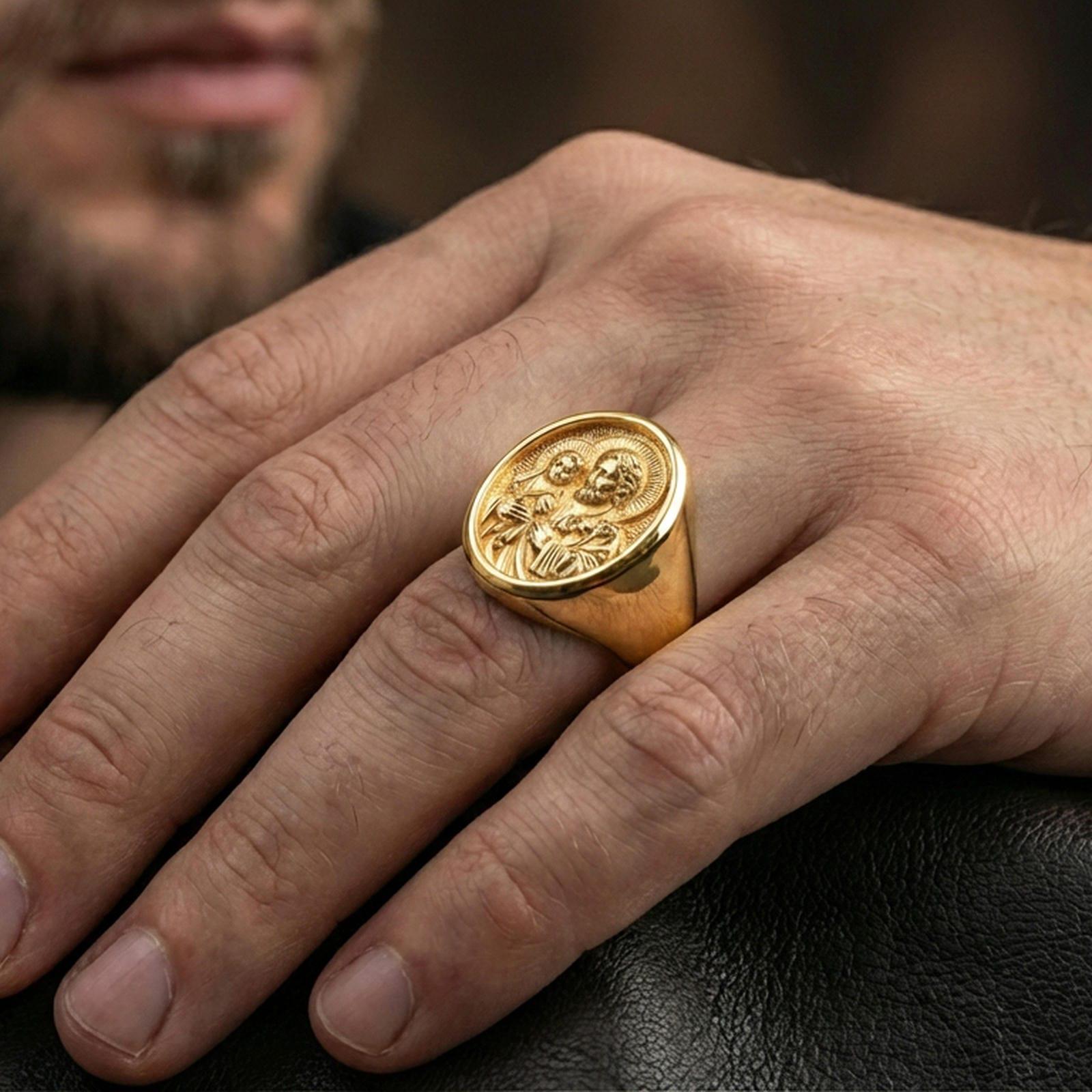 Gold plated St Joseph signet ring worn on finger, meaningful Christian gift for him closeup