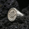Load image into Gallery viewer, Polished silver Saint Mark ring on volcanic stone, evangelist symbol signet macro closeup
