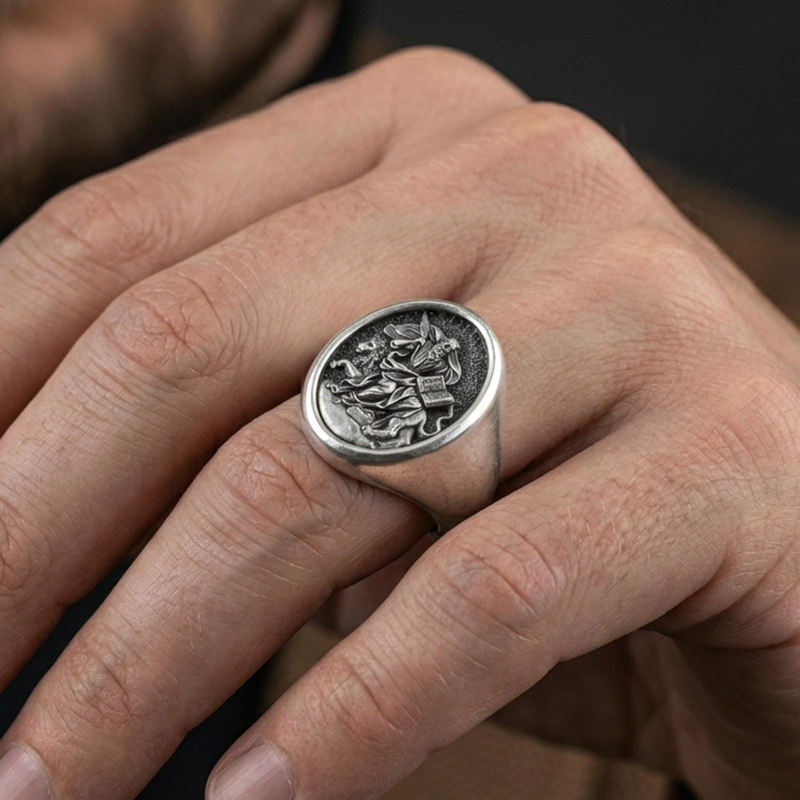 Oxidized St Mark signet ring worn on finger, winged lion and bible relief Catholic jewelry