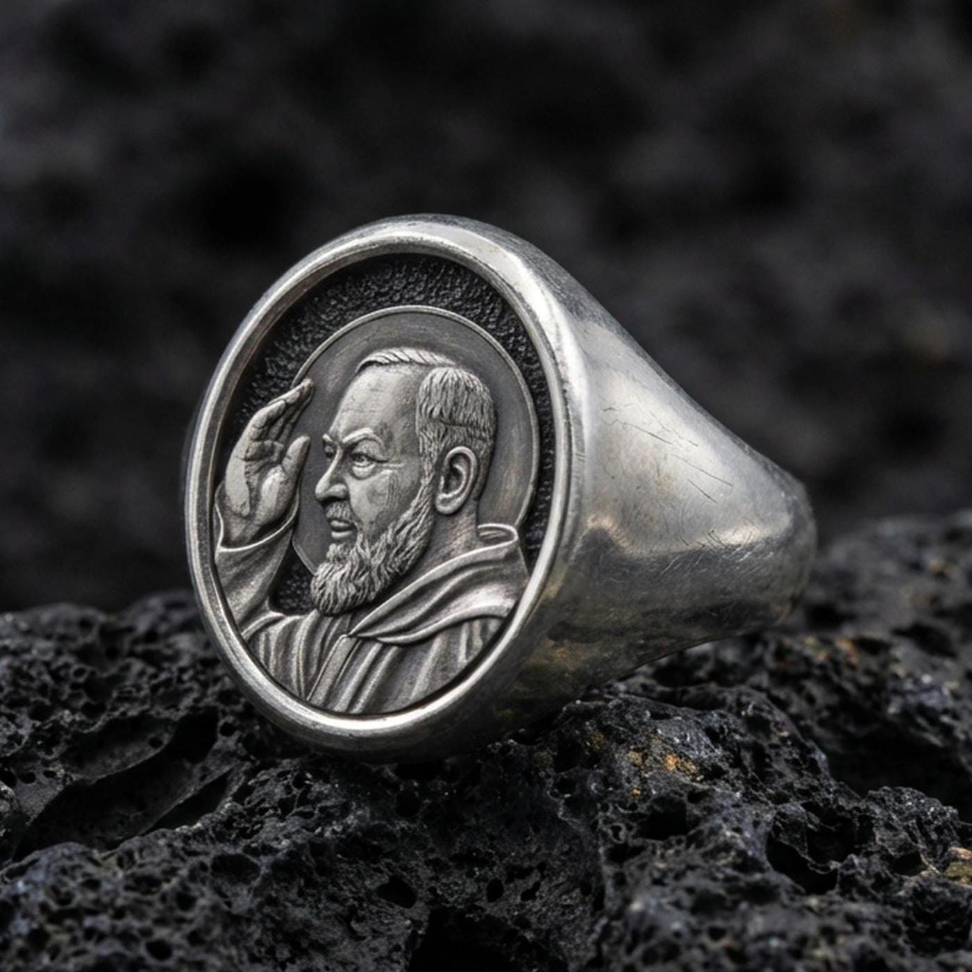 Oxidized 925 sterling silver Padre Pio signet ring on volcanic rock, saint portrait relief, Catholic devotional jewelry
