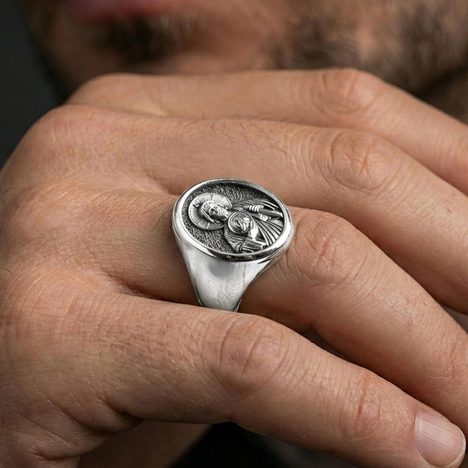 Polished silver Saint Jude signet ring on hand, Catholic religious mens ring close view