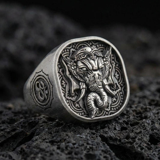 Oxidized 925 sterling silver Lord Ganesha signet ring on volcanic rock, detailed elephant head relief, Hindu amulet
