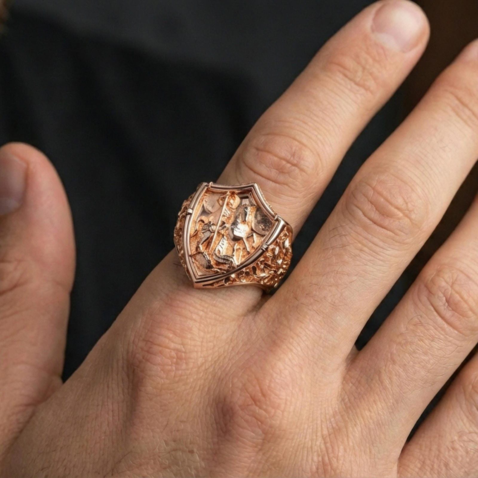 Rose gold plated Saint George dragon slayer ring worn on finger, ornate shield signet style, religious gift jewelry