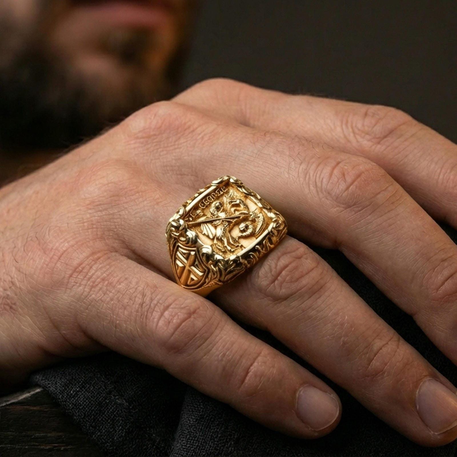 Gold plated St George defeating dragon signet ring worn on finger, medieval warrior motif, bold religious accessory