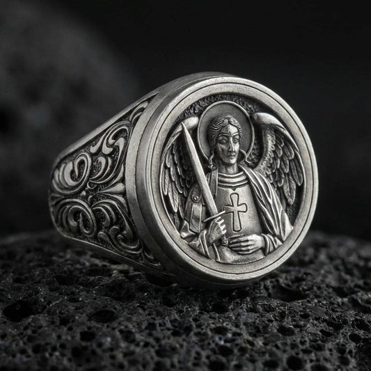 Oxidized 925 sterling silver St Michael archangel ring on volcanic rock, angel wings relief, sword and cross armor