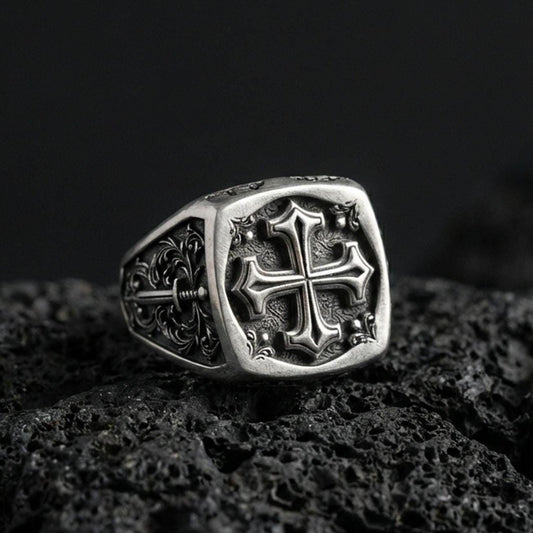 Oxidized 925 sterling silver crusader cross signet ring on volcanic rock, medieval Christian cross relief, ornate band