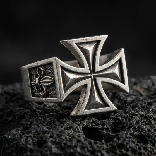 Oxidized 925 sterling silver iron cross signet ring on volcanic rock, bold raised cross relief, rugged vintage finish
