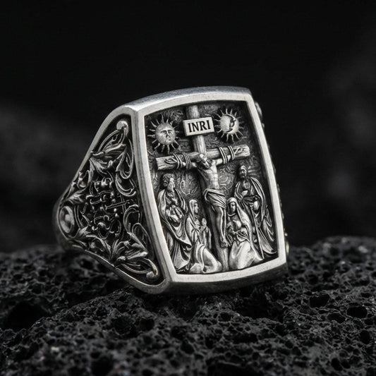 Oxidized 925 sterling silver INRI crucifix signet ring on volcanic rock, detailed Jesus on cross relief, cathedral-style engraving