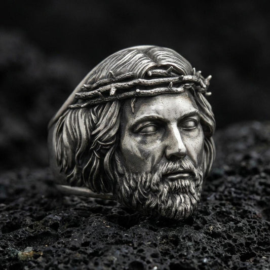Oxidized 925 sterling silver Jesus head ring on volcanic rock, crown of thorns relief, realistic portrait statement jewelry