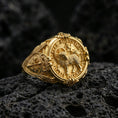 Load image into Gallery viewer, Gold plated Agnus Dei signet ring on dark volcanic rock, Lamb of God seal with Latin inscription, engraved cross shoulders
