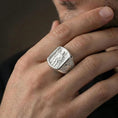 Load image into Gallery viewer, Polished silver Saint Roch signet ring worn on finger, religious protection symbol, detailed saint relief and patterned shoulders
