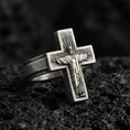 Load image into Gallery viewer, Oxidized 925 sterling silver crucifix ring on volcanic rock, Jesus on cross relief, minimalist Christian faith statement design
