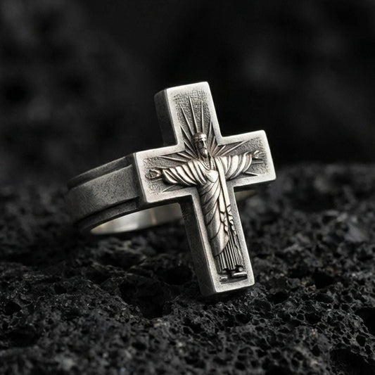 Oxidized 925 sterling silver crucifix ring on volcanic rock, Jesus on cross relief, minimalist Christian faith statement design
