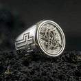 Load image into Gallery viewer, Polished silver Christian monogram signet ring on porous volcanic stone, raised monogram seal and side cross detail
