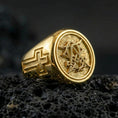 Load image into Gallery viewer, Gold plated Christian monogram signet ring on dark volcanic rock, monogram emblem with cross band, faith symbol ring
