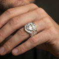 Load image into Gallery viewer, Polished silver heraldic cross shield signet ring worn on finger, raised shield crest and fleur-de-lis cross detail
