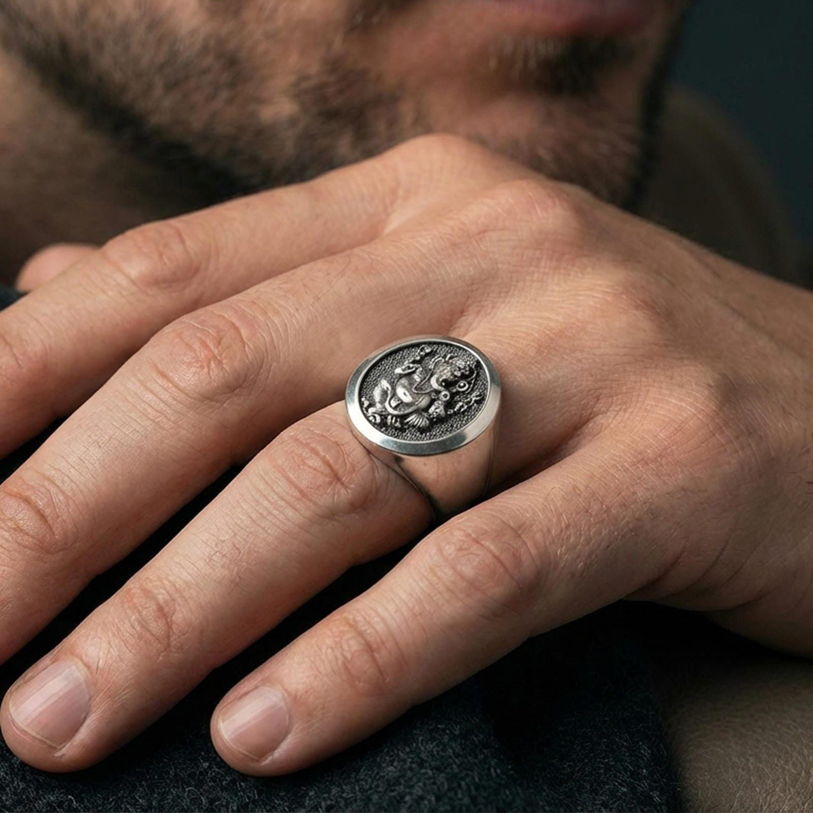 Oxidized 925 sterling silver Ganesha signet ring worn on finger, detailed elephant deity relief ring with spiritual symbolism