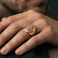 Load image into Gallery viewer, Rose gold plated Ganesha signet ring worn on finger, oval Ganesha signet ring with textured background and spiritual meaning
